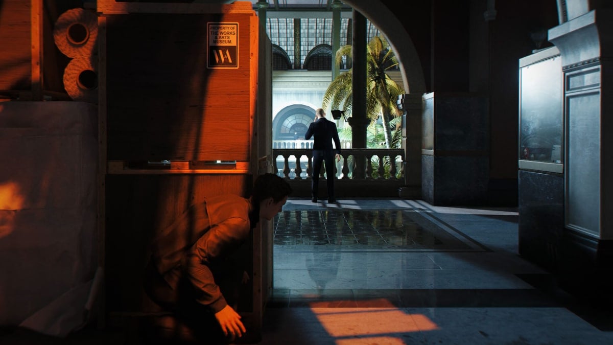 Bond hiding around a corner from a guard in 007 First Light